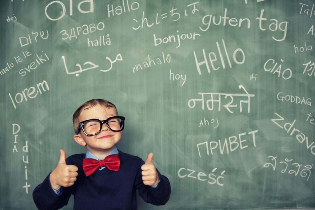 A young language master boy knows how to say hello in many different languages. All languages and cultures are beautiful.