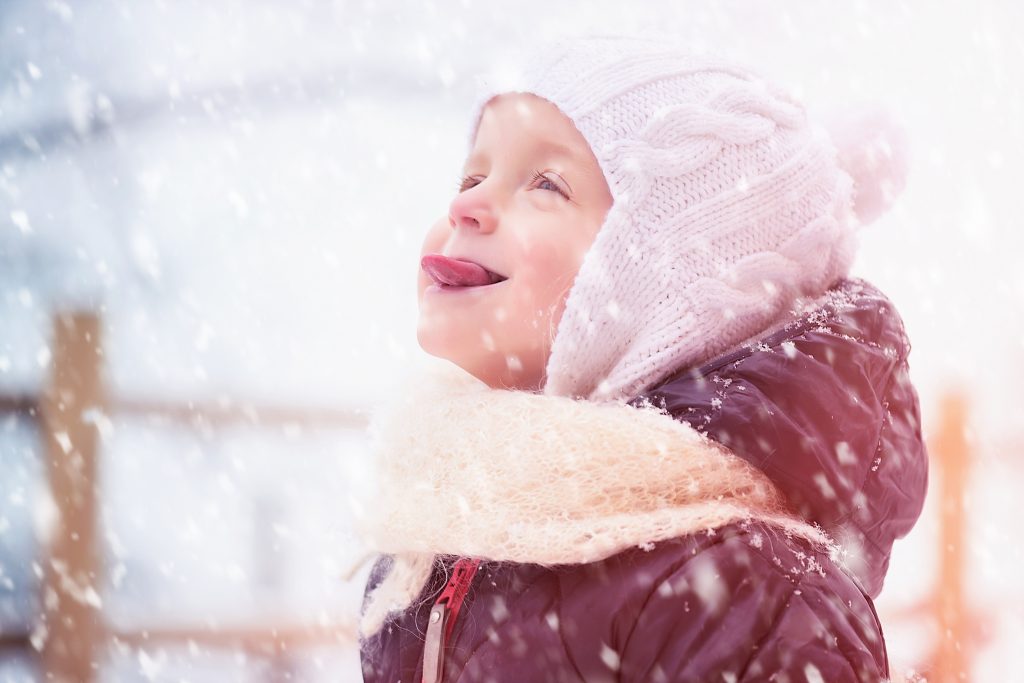 Girl Catching Snowflakes with Tongue
