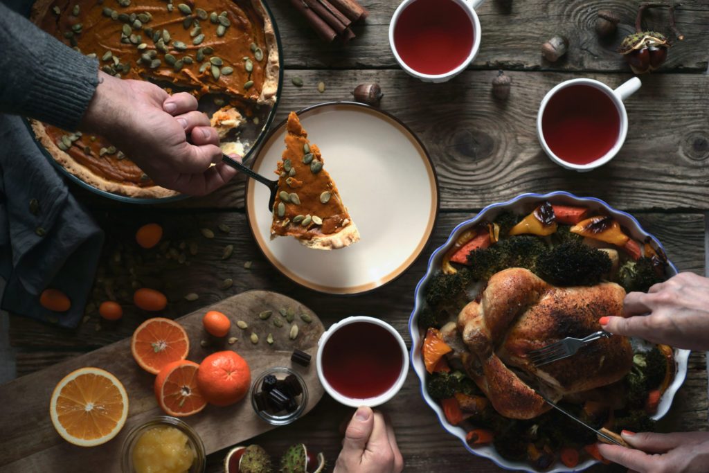 Turkey with vegetable , pumpkin pie and tea on the wooden table top view horizontal