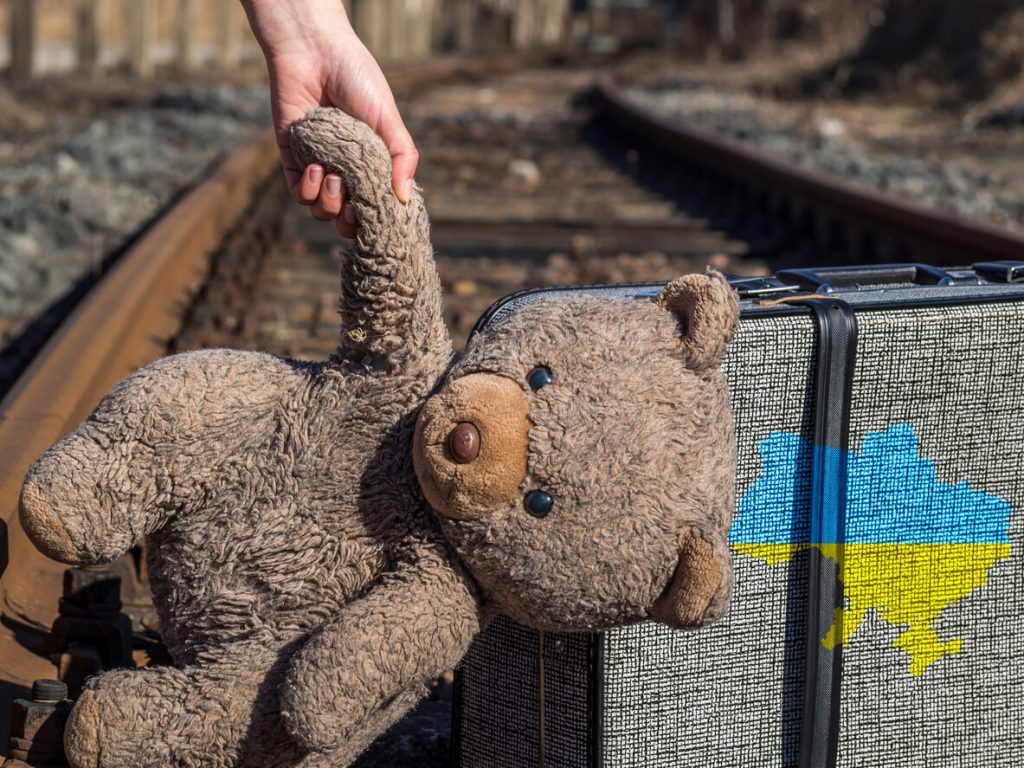 A teddy bear and suitcase in Ukraine as they escape war