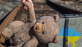 A teddy bear and suitcase in Ukraine as they escape war
