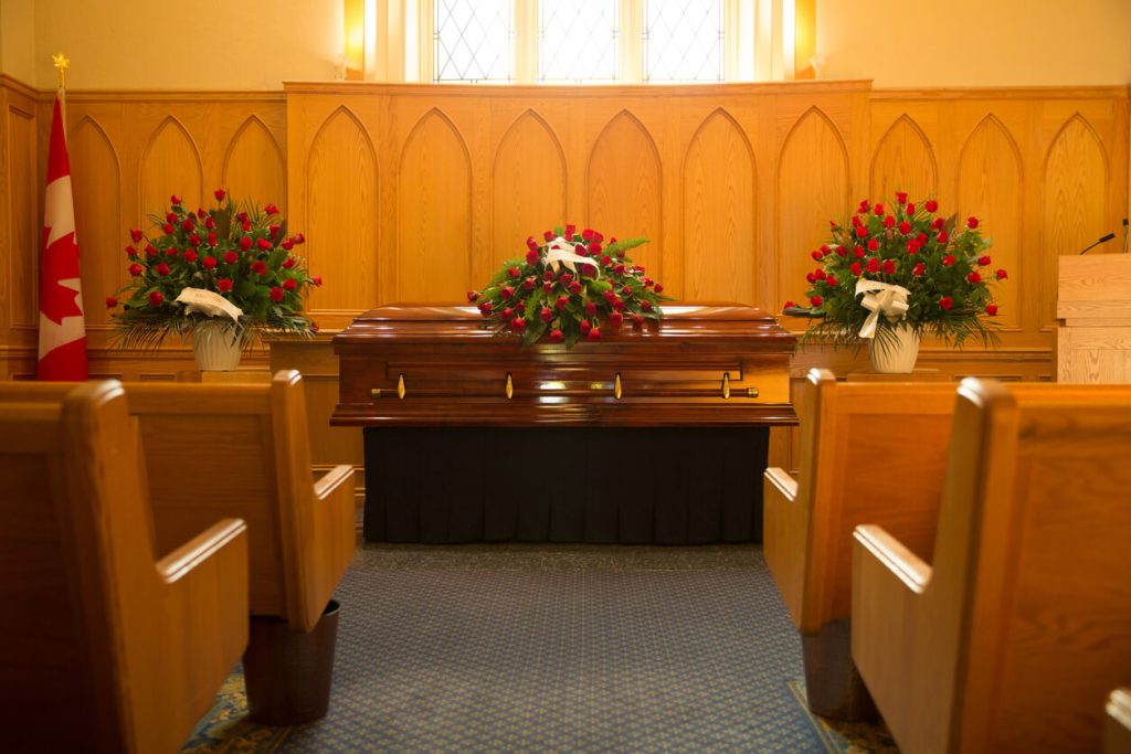 A casket at the front of a church during a funeral