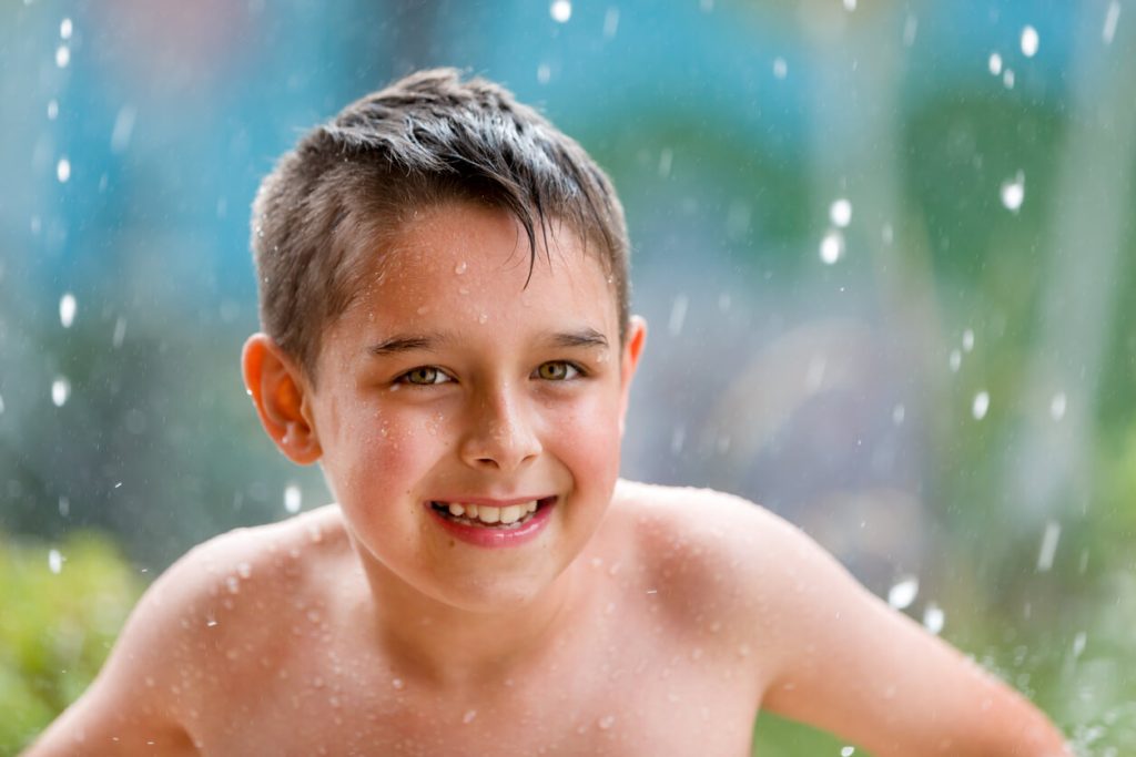 A young boy playing in the water.